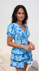 Solira Floral Tiered Mini Romper Dress in Blue back view on model
