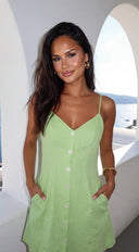 Elira Linen Mini Dress in Lime Green fabric drape close-up hemline and silhouette detail