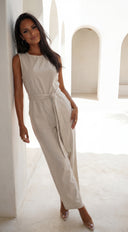 Zaylina Linen Waist Tie Jumpsuit in Natural Beige fabric drape close-up hemline and silhouette detail