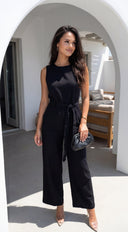Zaylina Linen Waist Tie Jumpsuit in Black fabric drape close-up hemline and silhouette detail
