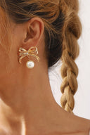 Twinkling Rhinestone Bow Pearl Drop Earrings in Gold close-up detail shot