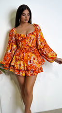 Mel Orange Multi Color Floral Print Romper side profile view on model