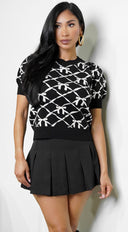 Sara Pleated Skort in Black styled outfit flat lay