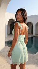 Mintéa Ruffle Trim Mini Dress in Green fabric drape close-up hemline and silhouette detail