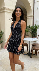 Bellavina Polka Dot Halter Mini Dress in Black detail shot of stitching and finish hemline and silhouette deta texture detail